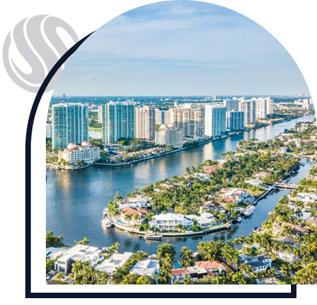 View of a city with buildings, houses and a canal